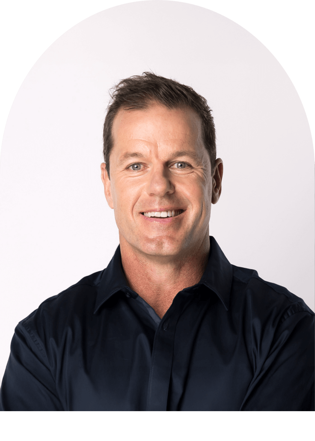 Man wearing a dark blue shirt against a white background